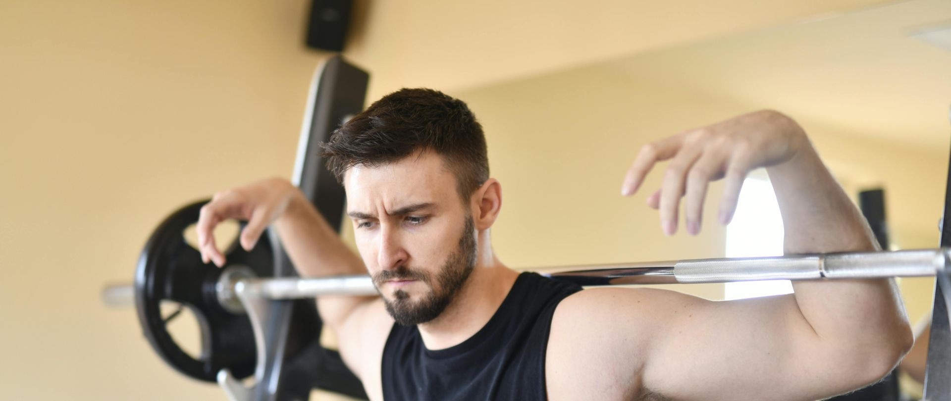 man in black tank top exercising