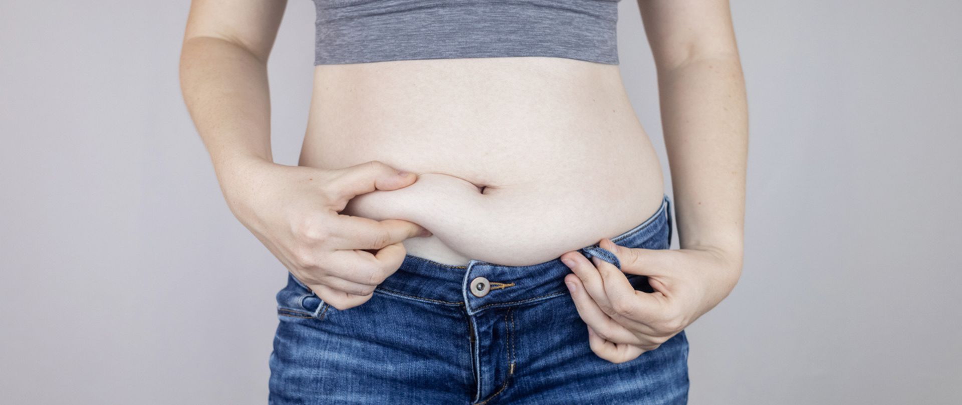 woman pinching belly fat