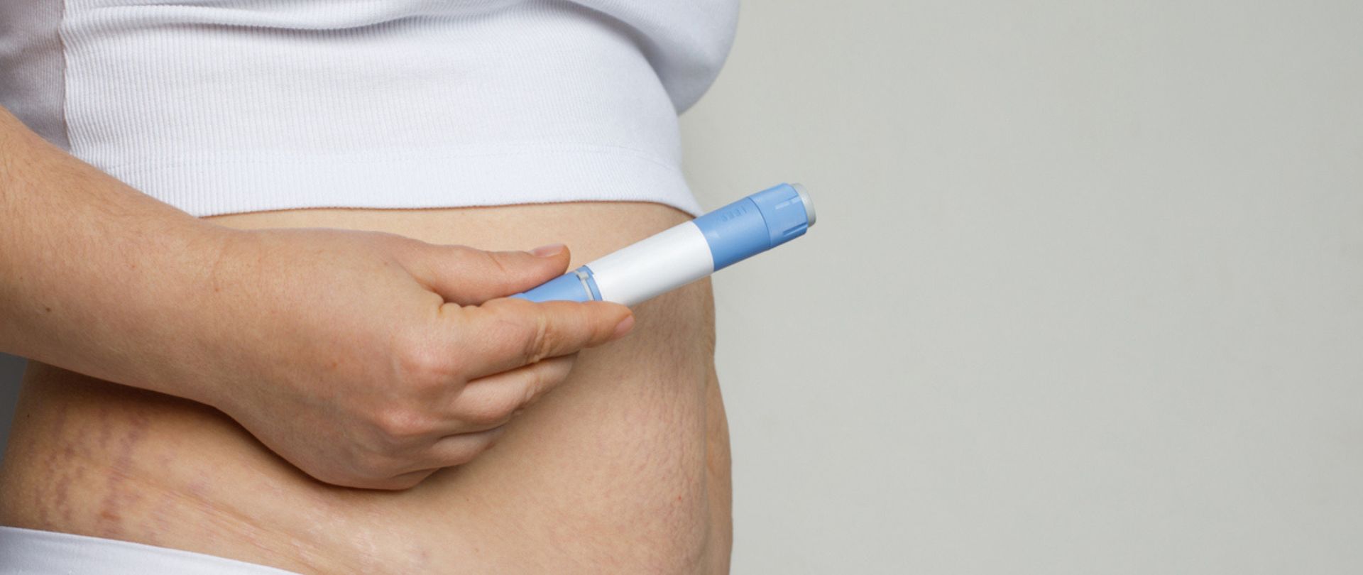 woman holding GLP-1 pen