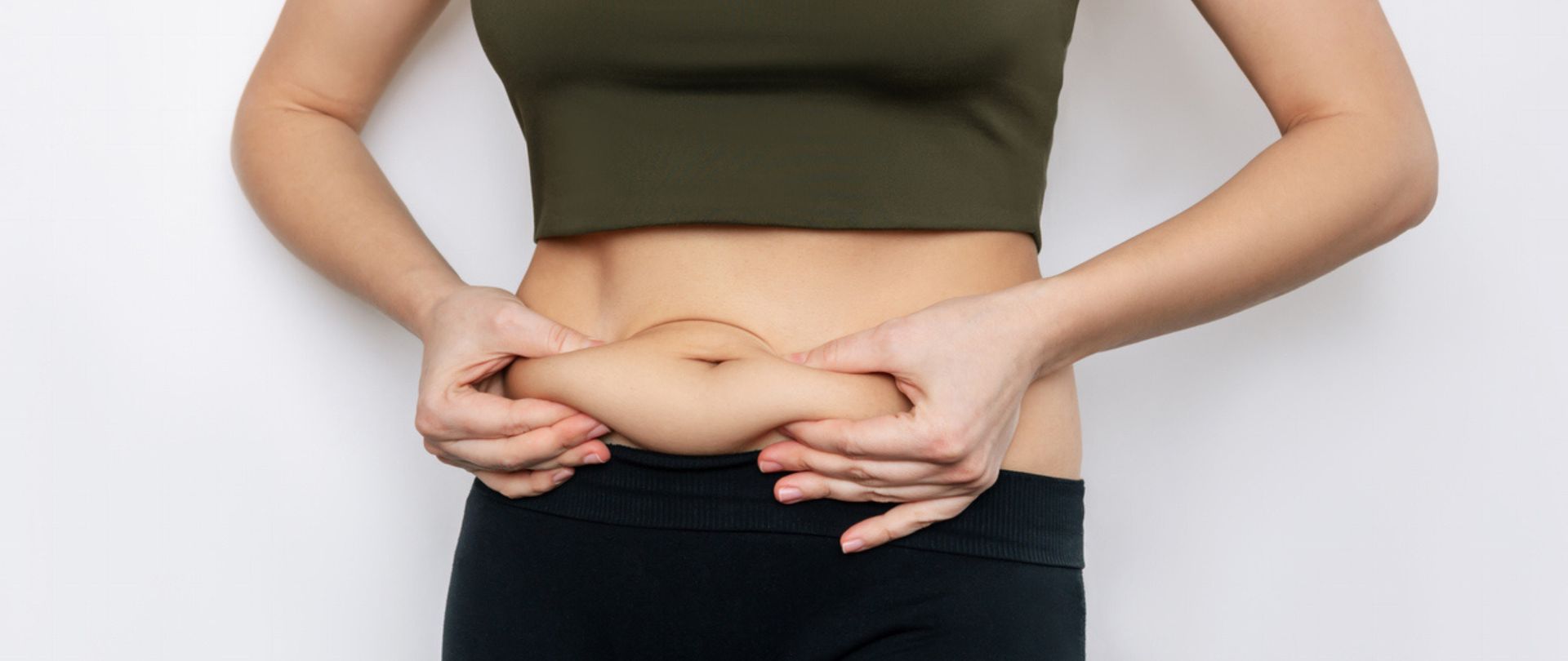 woman pinching stomach